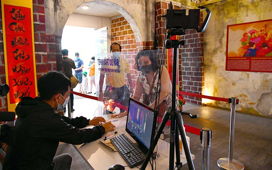 Visitors making a medical declaration before visiting Thang Long Imperial Citadel 